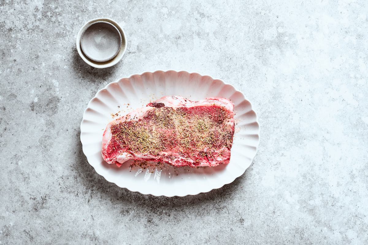 seasoned raw frozen steak.