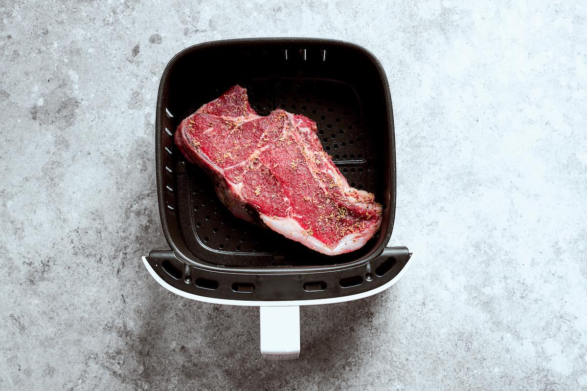 frozen seasoned raw steak in air fryer.