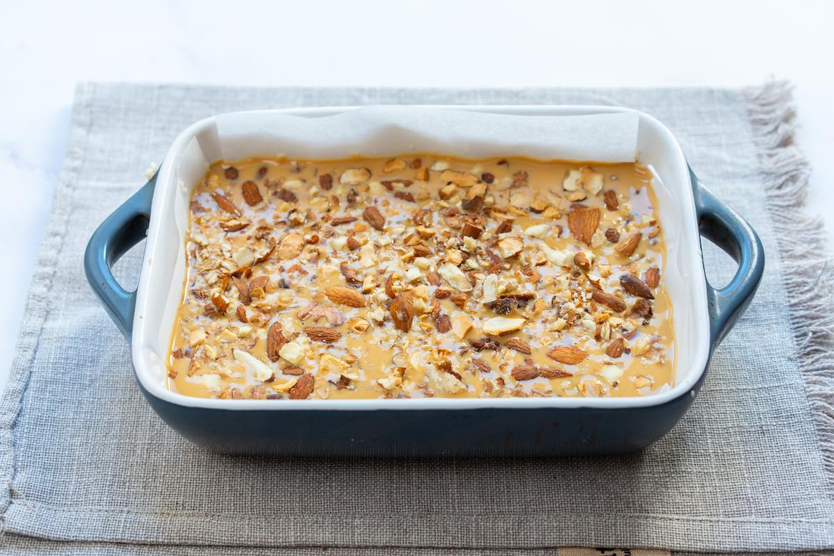 caramel layer on top of nougat with chopped nuts.