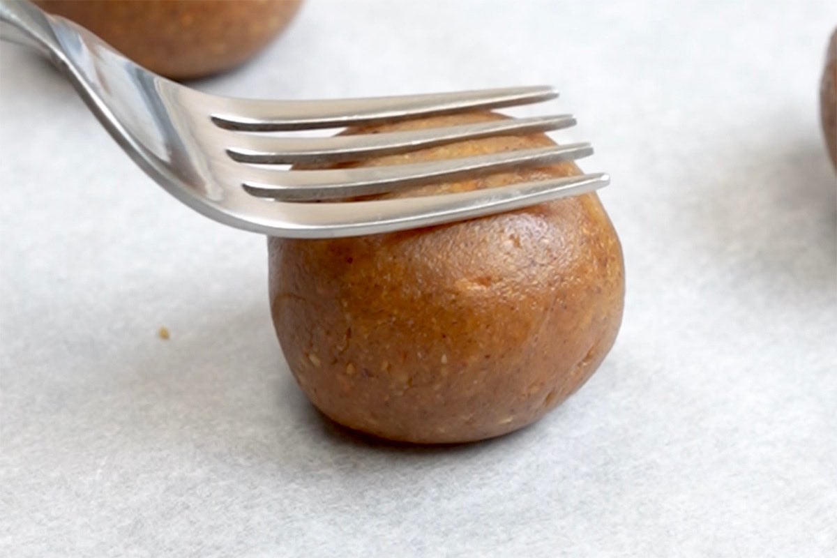 balls of cookie dough on a baking sheet.