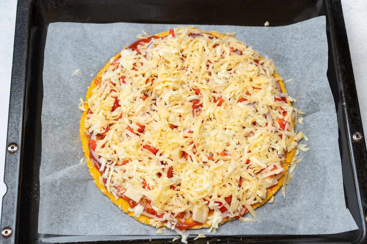 crust with shredded cheese and tomato sauce.