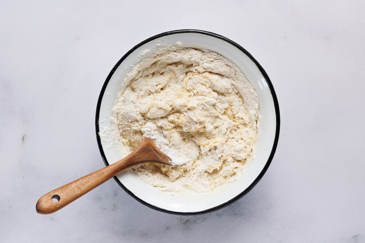 flour added to yeast mixture in bowl.