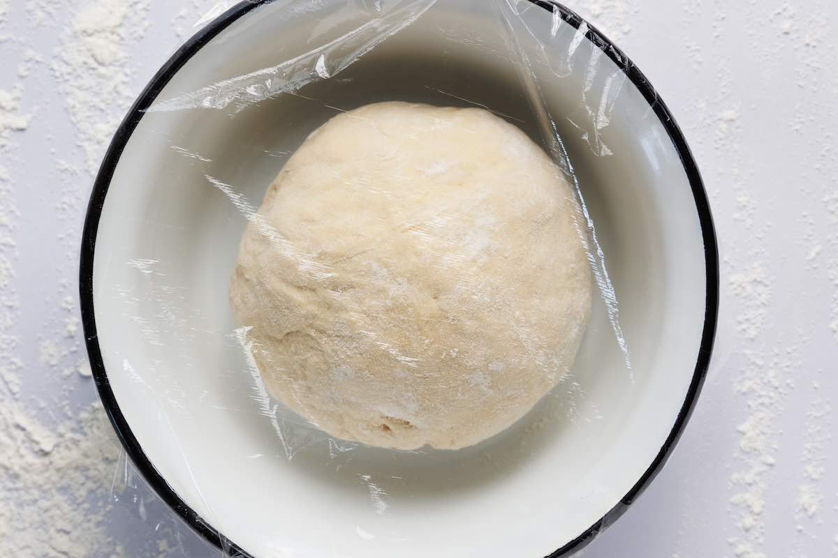 shaped dough proofing in bowl.