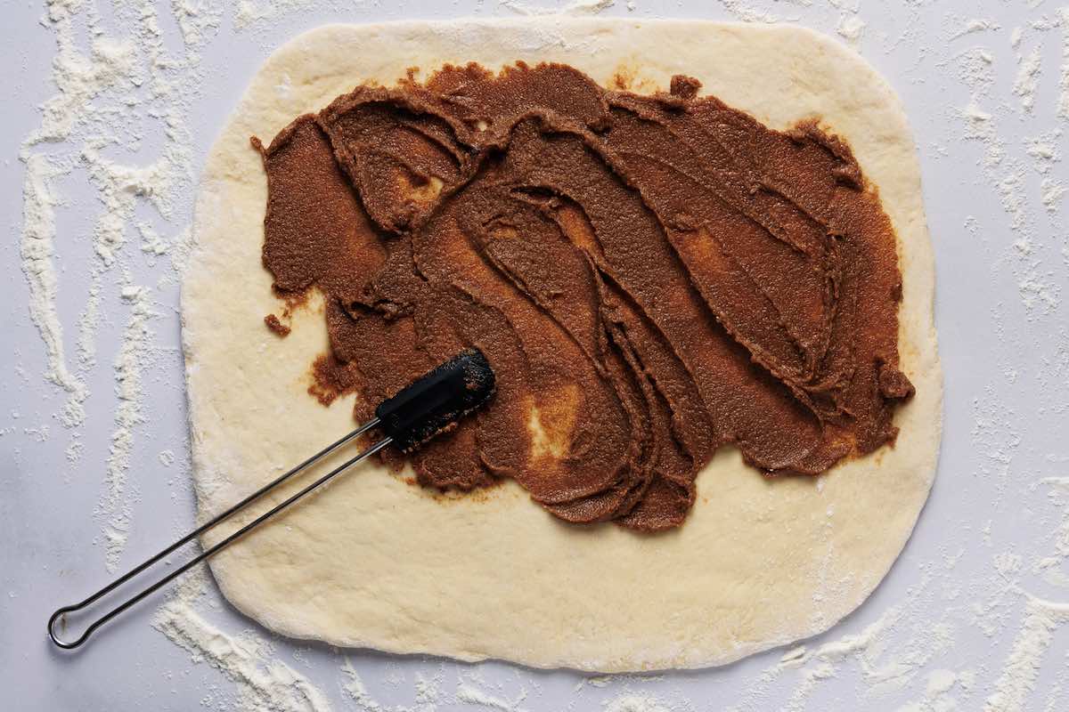 spreading cinnamon sugar mixture on dough.