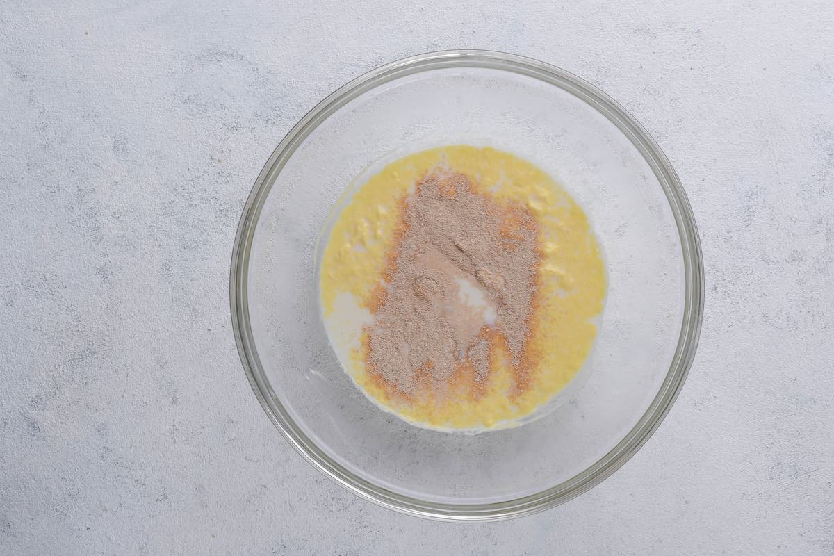 yeast, melted vegan butter, almond milk, and sugar in bowl.
