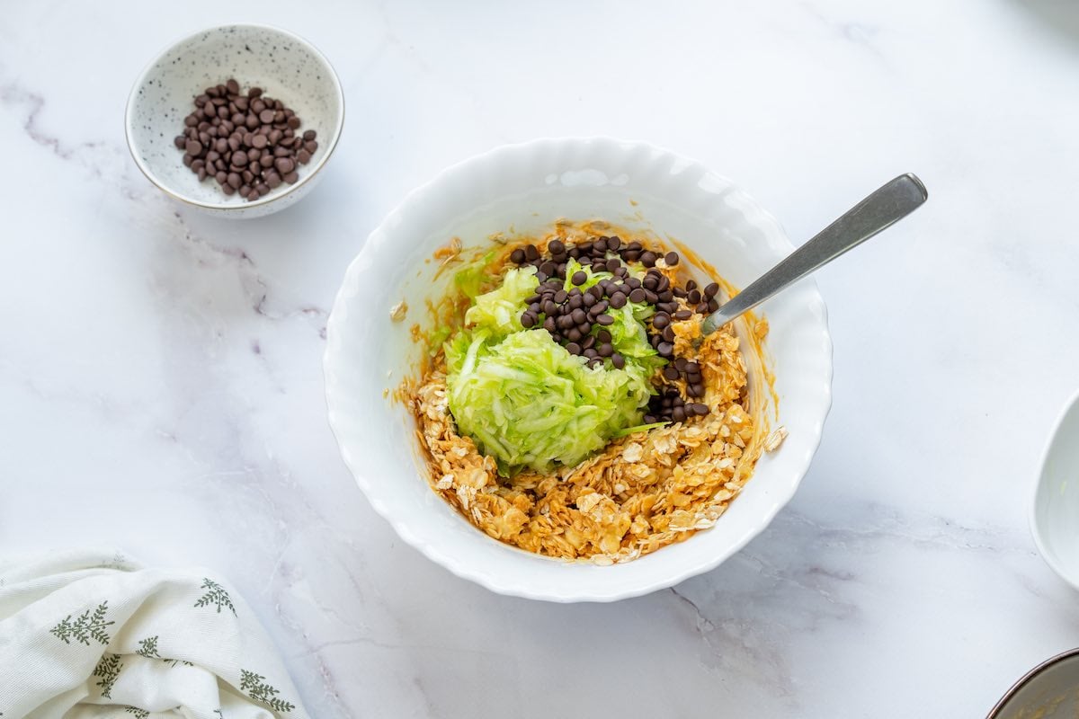 oats, zucchini, banana, chocolate chips, and peanut butter in a bowl.