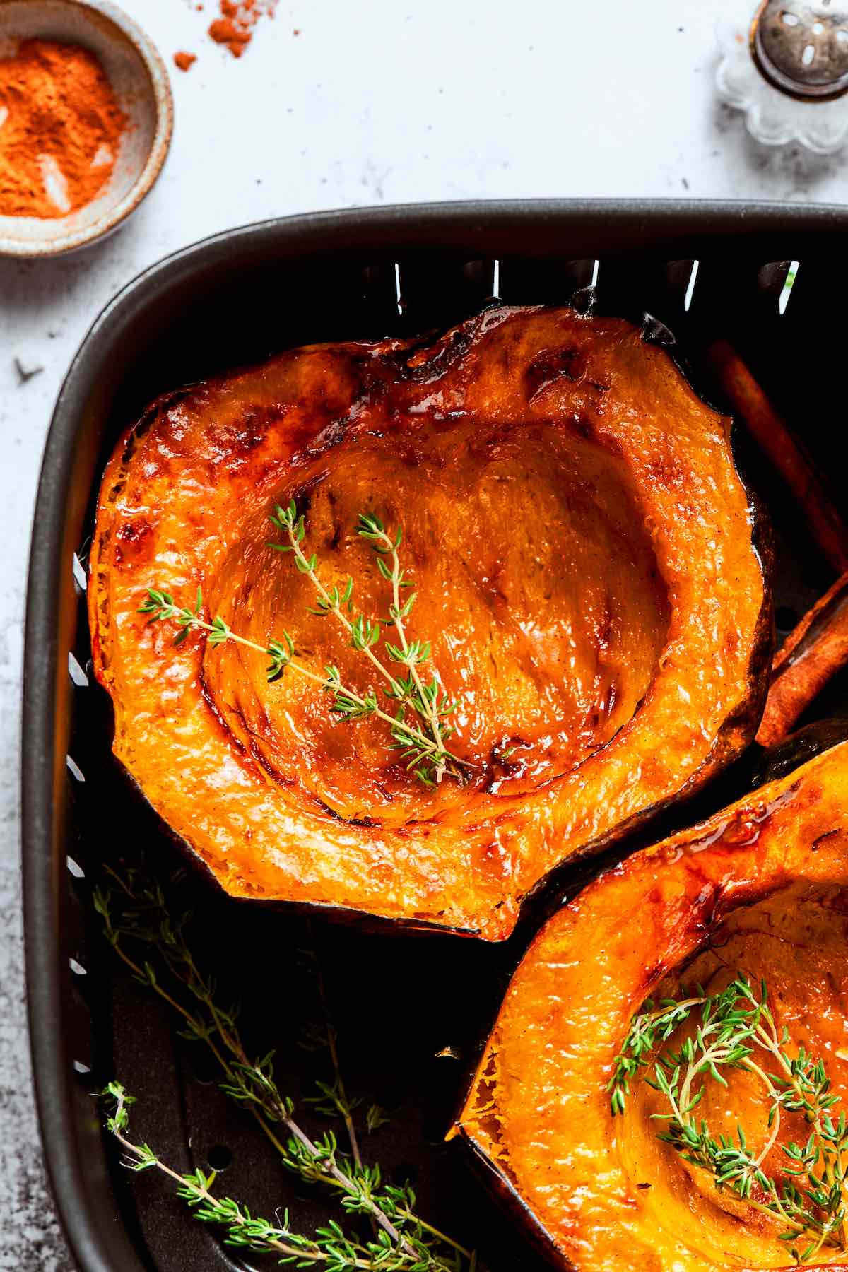air fried acorn squash in the air fryer basket.