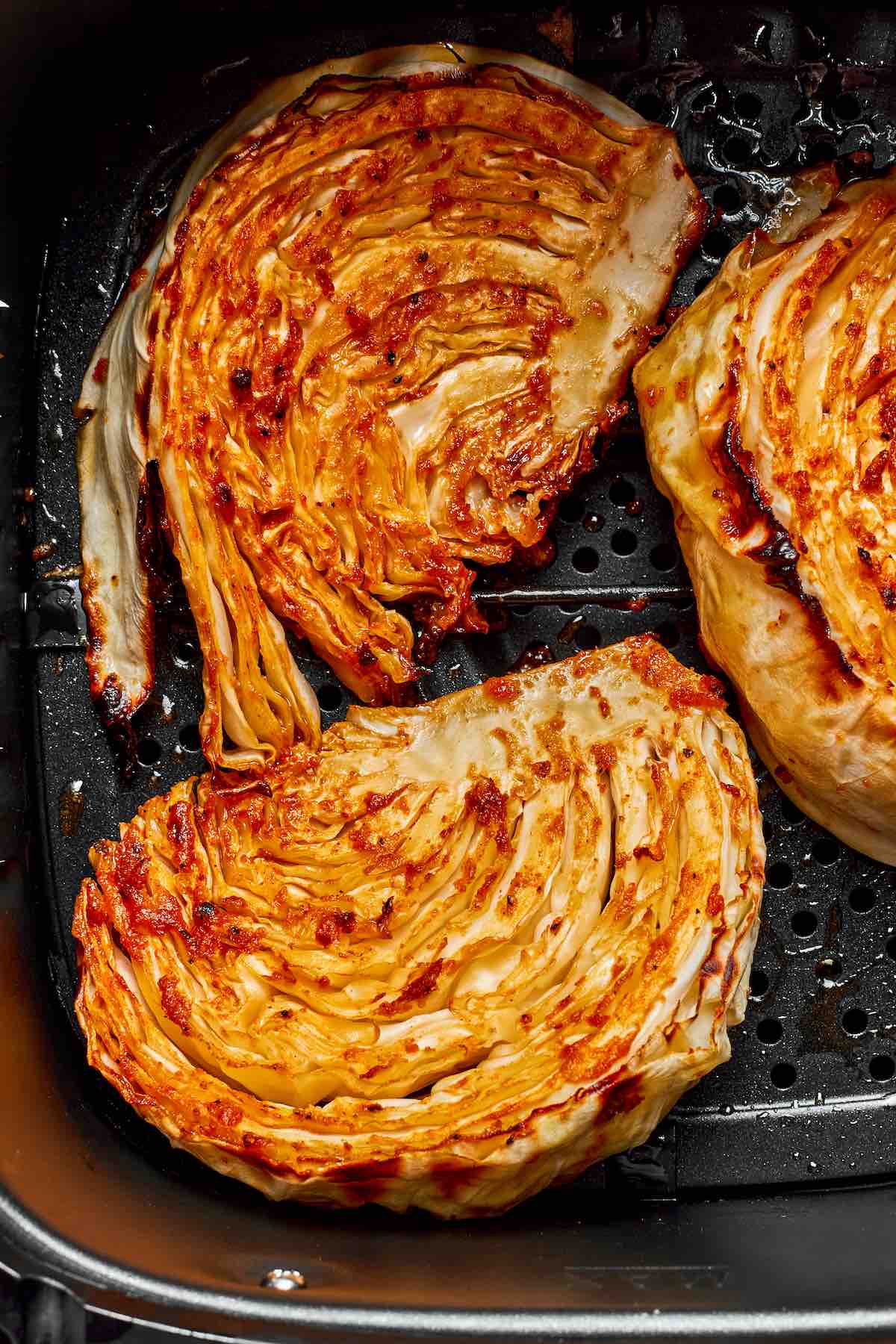 air fryer cabbage wedges in the air fryer basket.