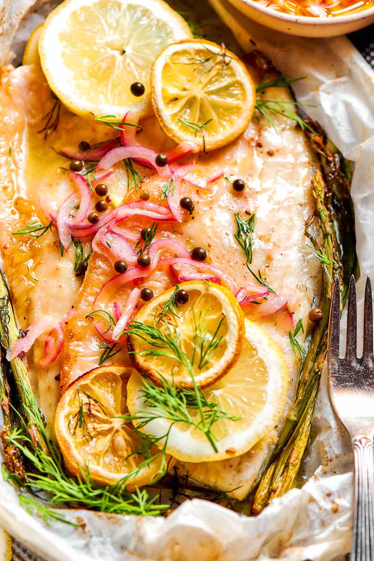 oven baked whiting with fresh lemon slices and dill.