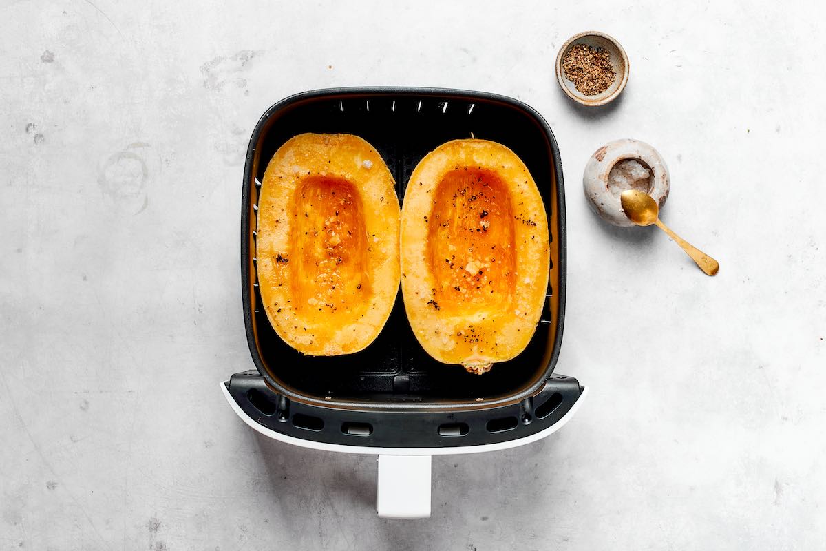 raw seasoned spaghetti squash halves in the air fryer.