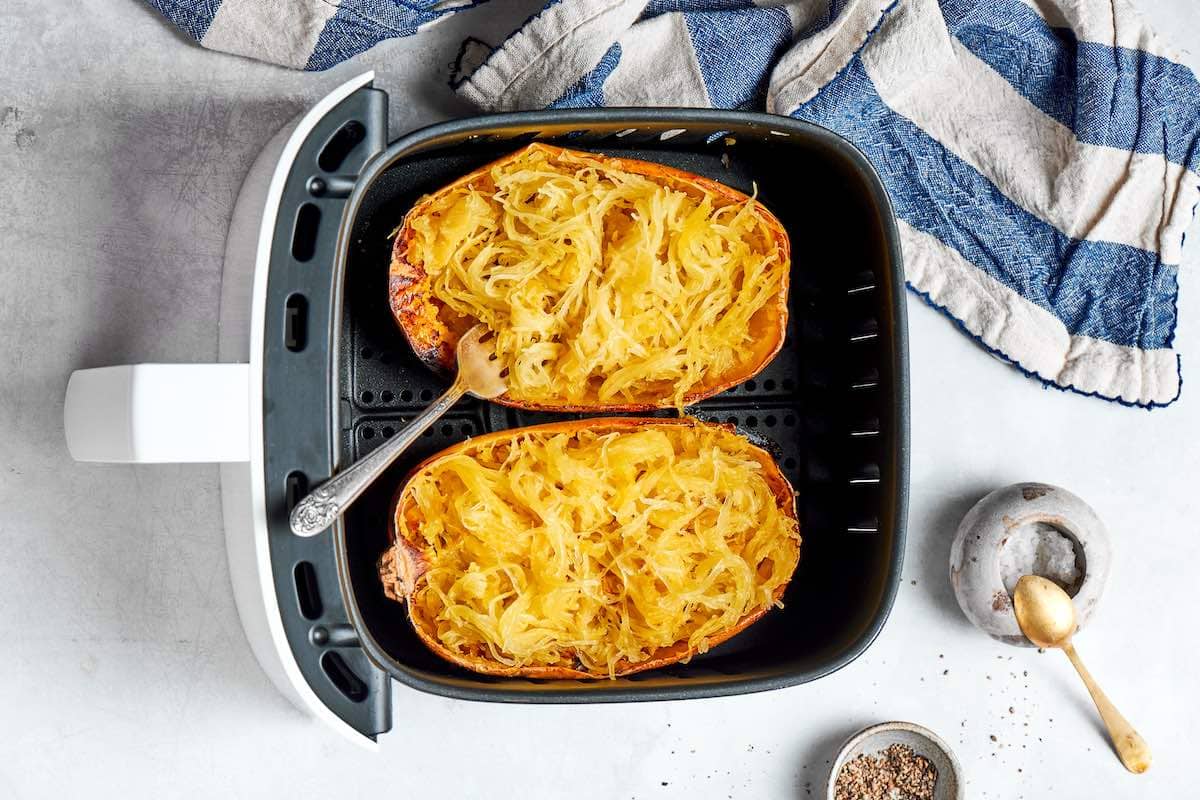pulling strands of spaghetti squash using a fork.