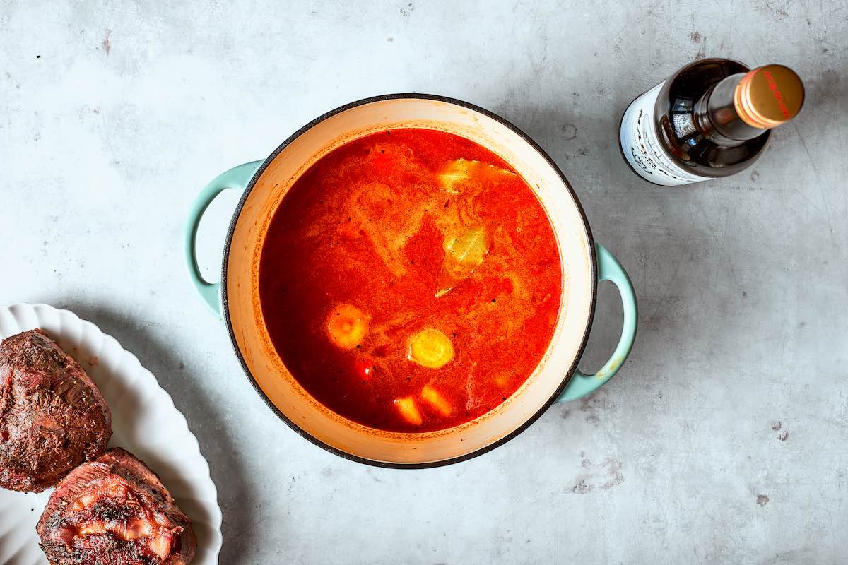 braising liquid in Dutch oven.