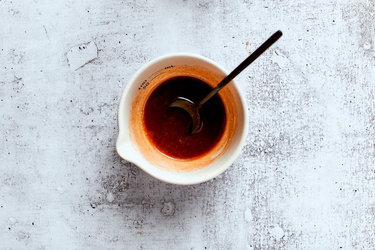 maple syrup, olive oil, and cinnamon in a small white bowl.