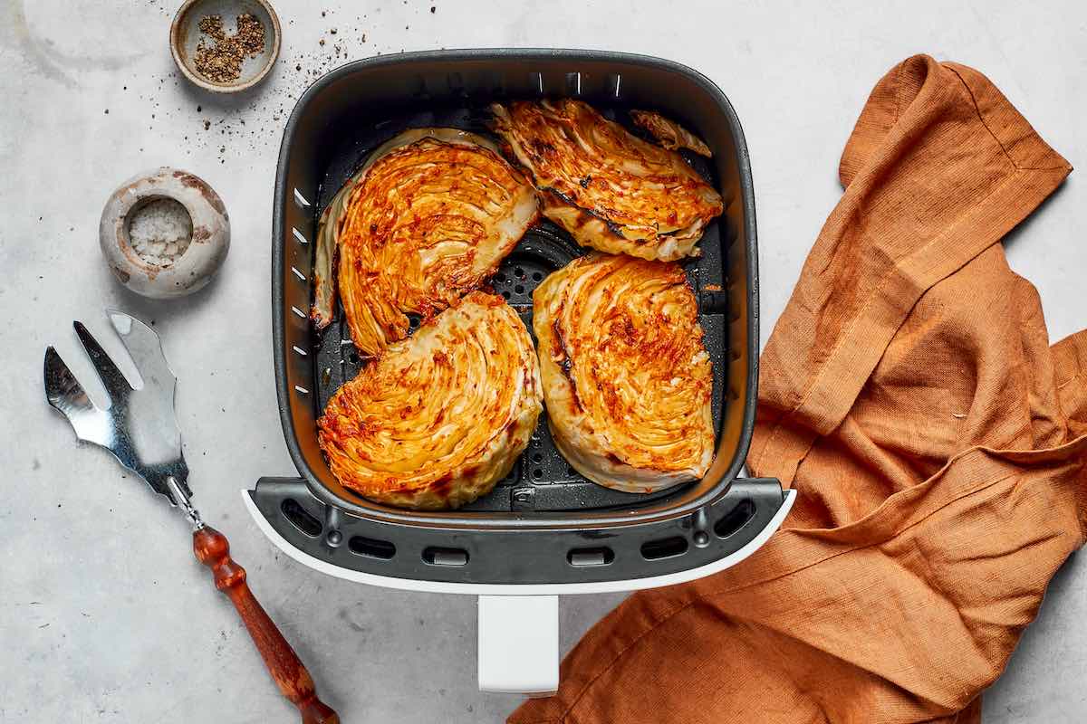 air fried cabbage in the air fryer basket.