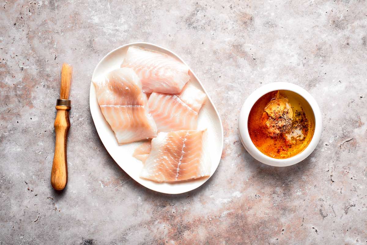 raw halibut fillets on a plate.