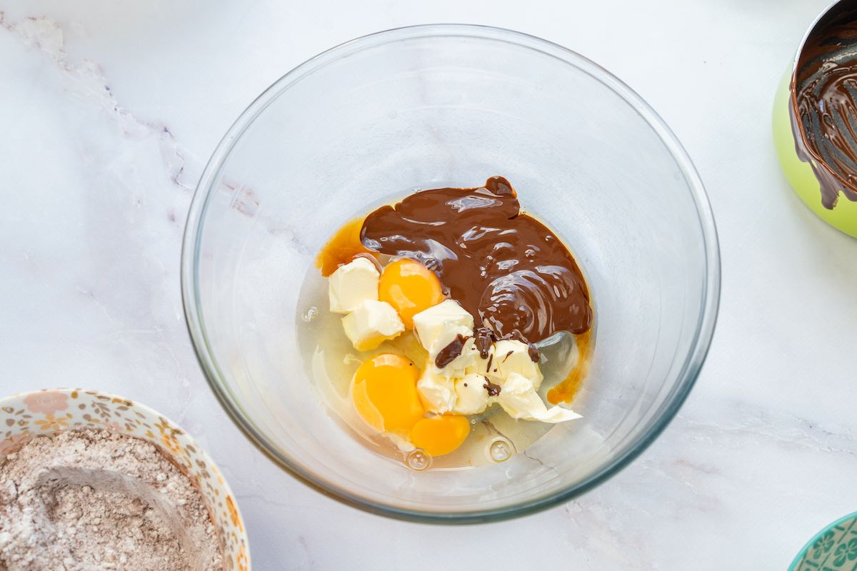 eggs, butter, melted chocolate in mixing bowl.