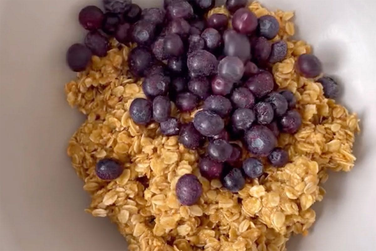 Folding blueberries into cookie dough.