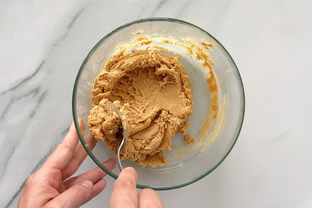 coconut flour, peanut butter, and maple syrup in a bowl.