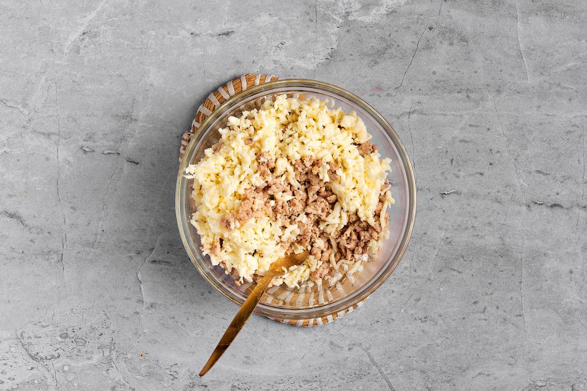 shredded cheese and cooked ground turkey in bowl.