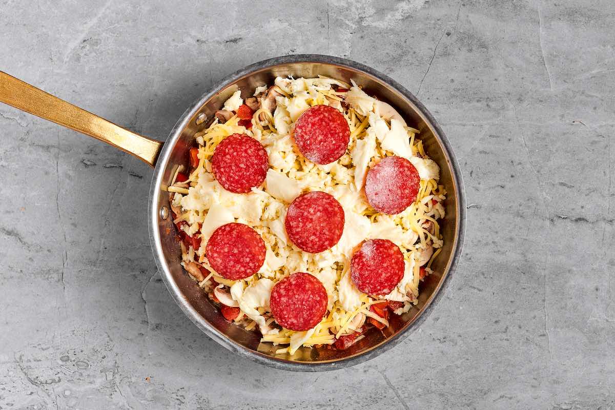 assembled crustless pizza in skillet.