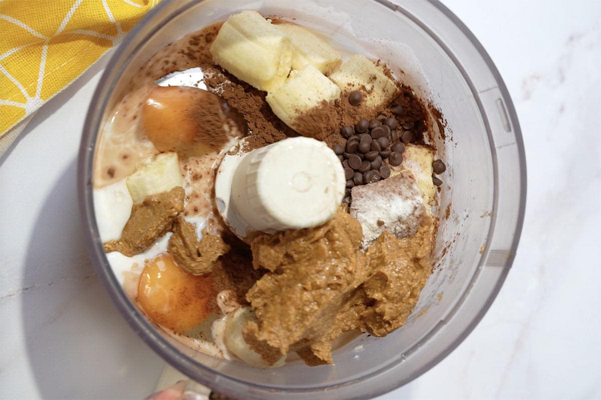 banana, almond butter, coccoa powder, eggs, milk, baking agents in blender.
