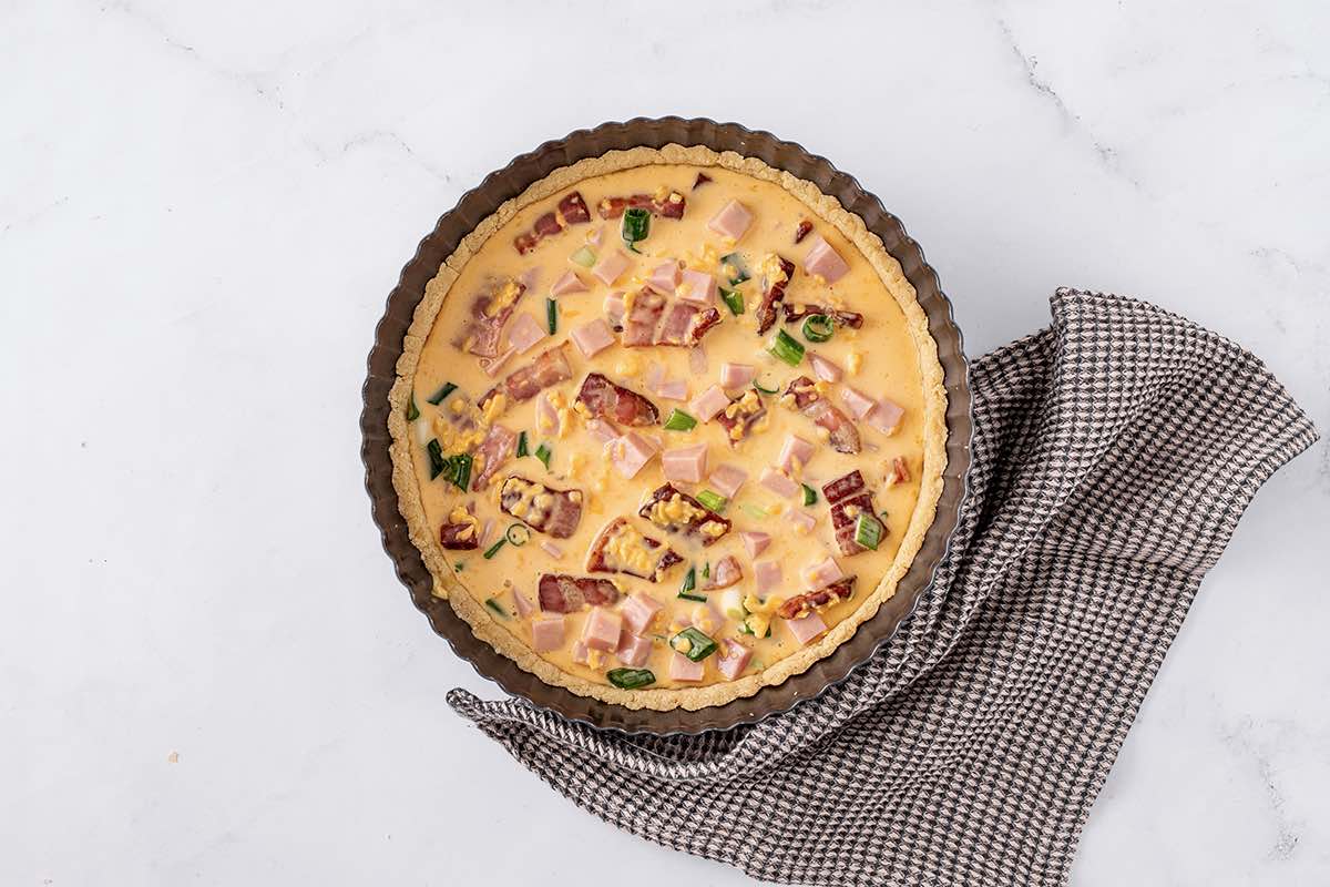 assembled and unbaked quiche.