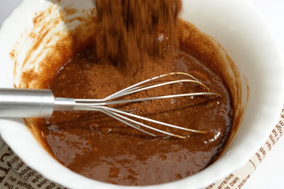 adding cocoa powder and cornstarch to wet ingredients.