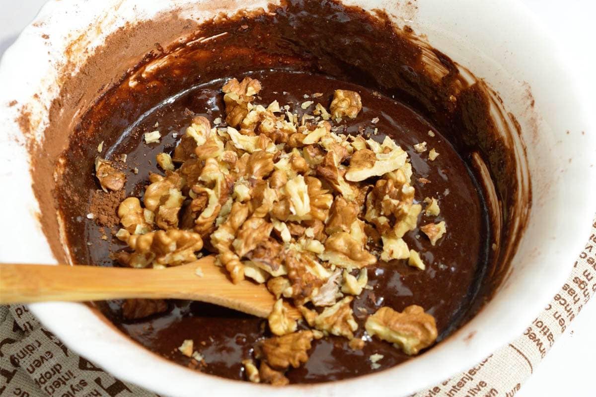folding walnuts into brownie batter.