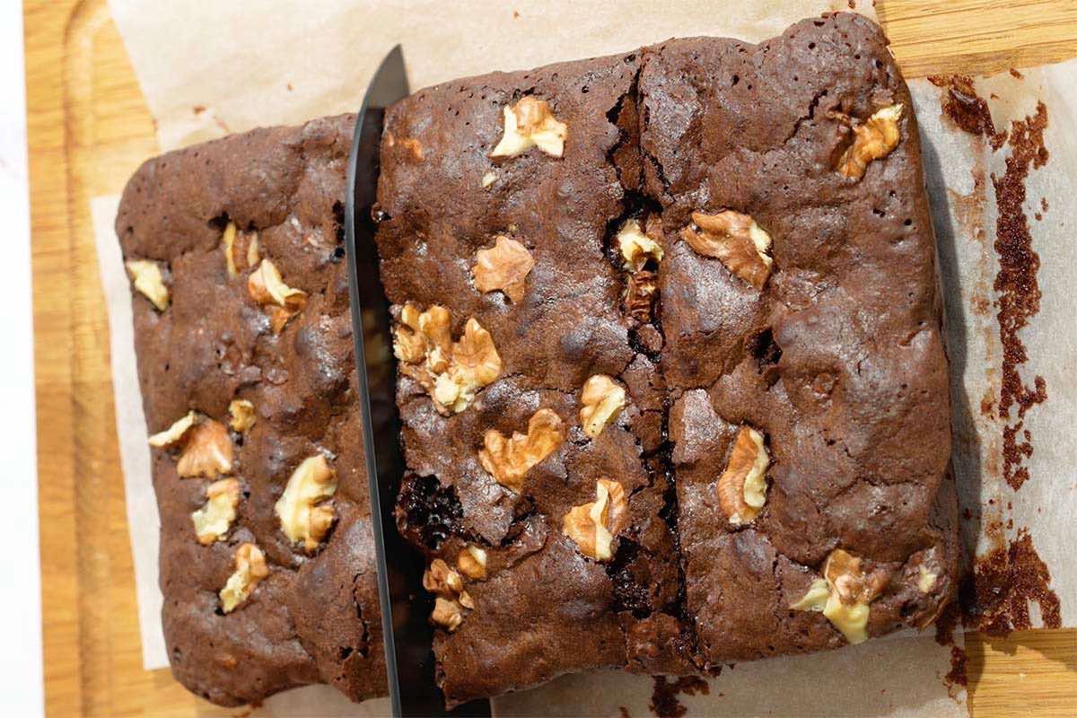 slicing walnut brownies.