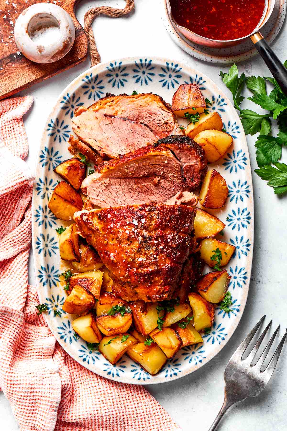 sliced pork shoulder roast with potatoes.