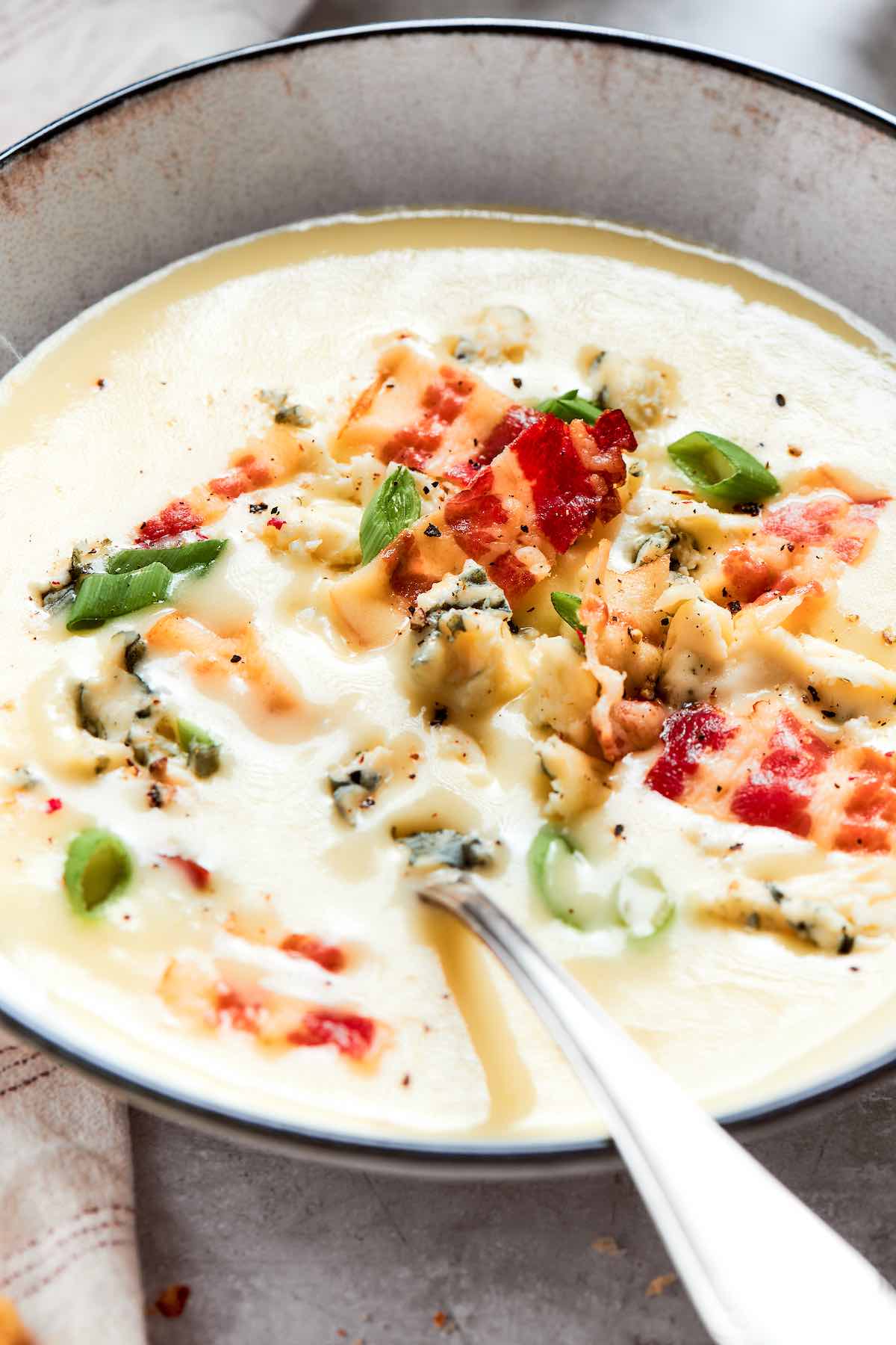 bowl of four ingredient potato soup with a spoon.