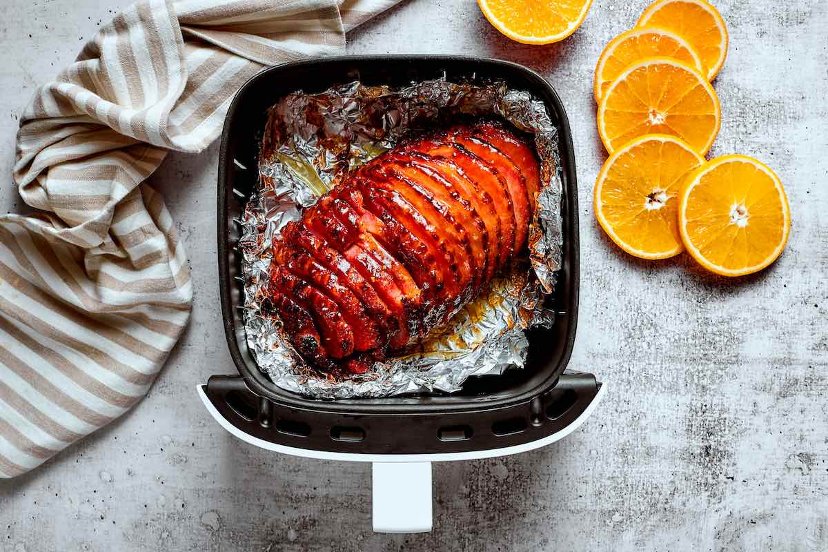 glazed air fryer ham in the air fryer basket.