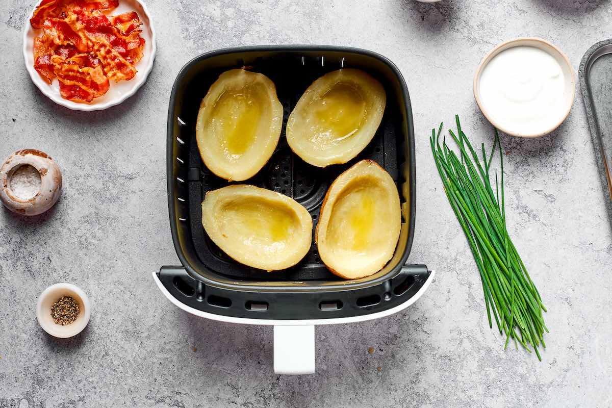 scooped out potatoes in the air fryer basket.