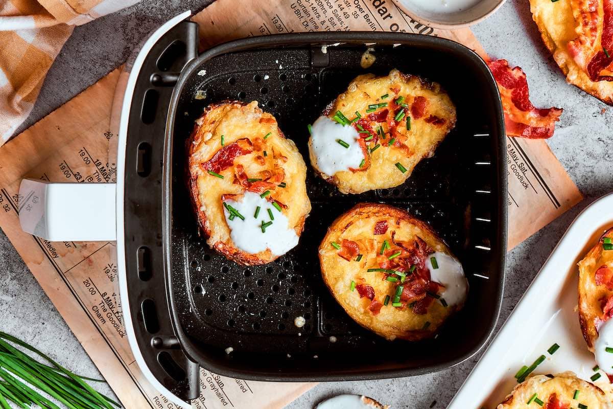 air fryer potato skins with crispy bacon, sour cream, and finely chopped scallions.