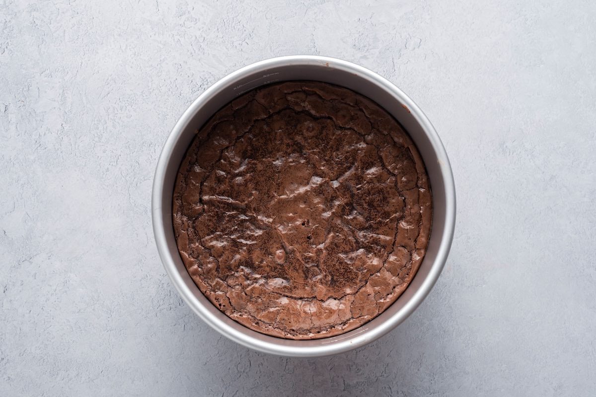 baked brownie base in cake tin.