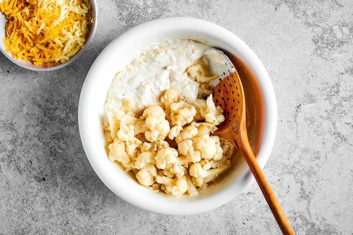 folding cooked cauliflower into the cheese sauce.