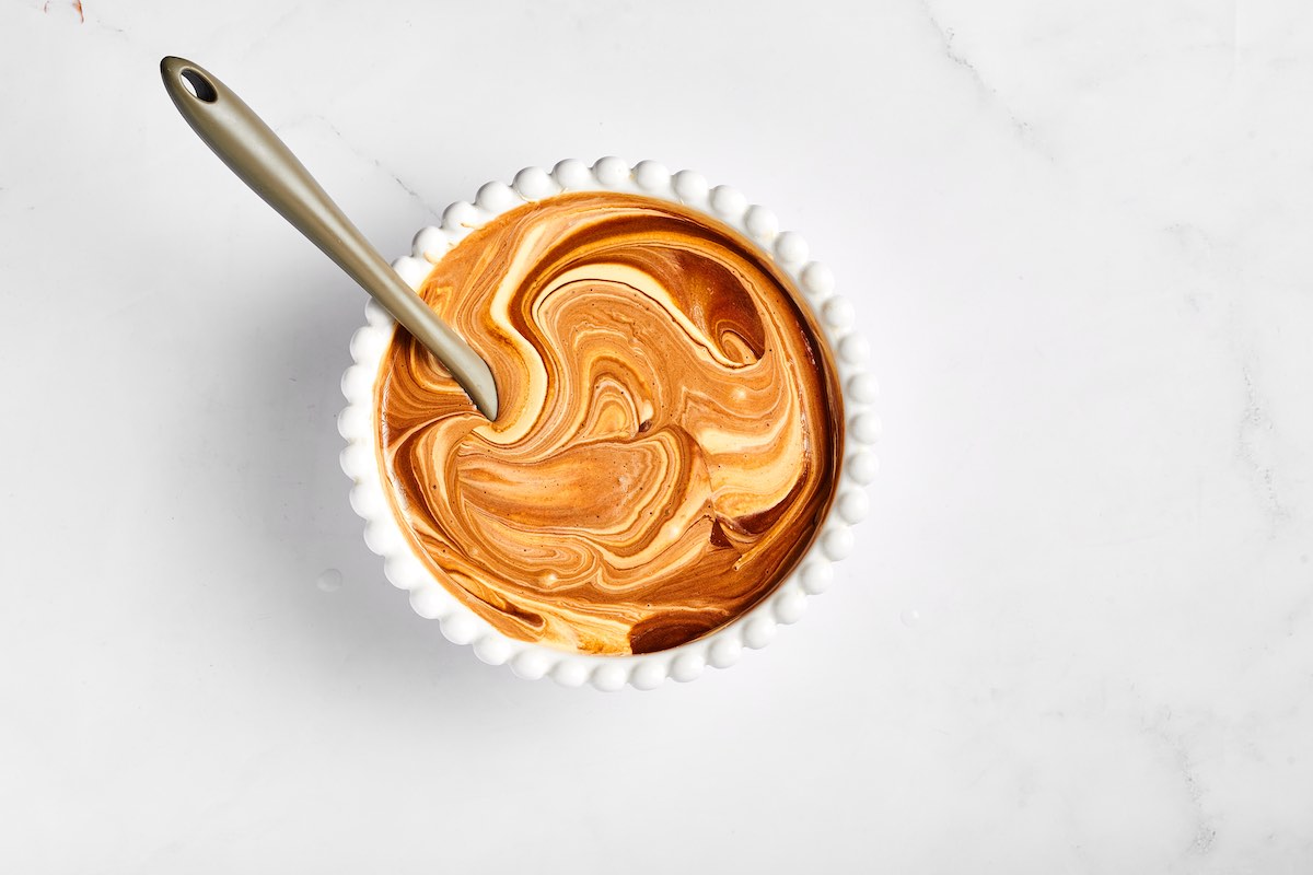 mixing egg yolk mixture with melted chocolate.