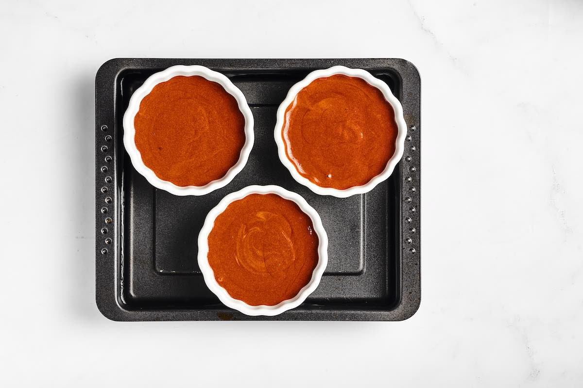 assembled chocolate creme brulees on baking dish.