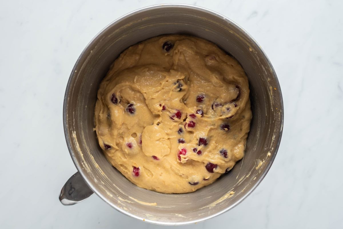 cranberry orange cake batter in a mixing bowl.