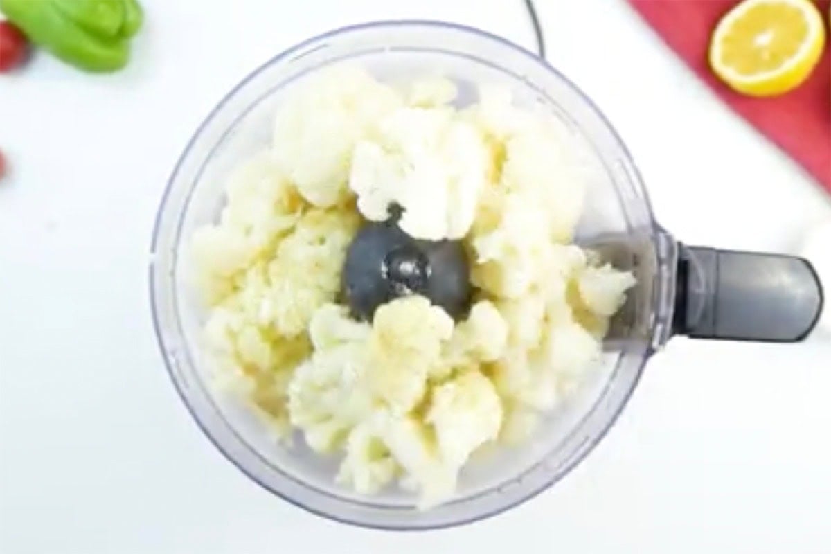 blending cooked cauliflower in a food processor.