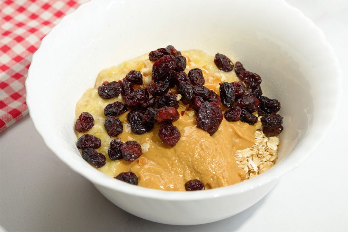mashed banana. almond butter, and oats in a bowl.