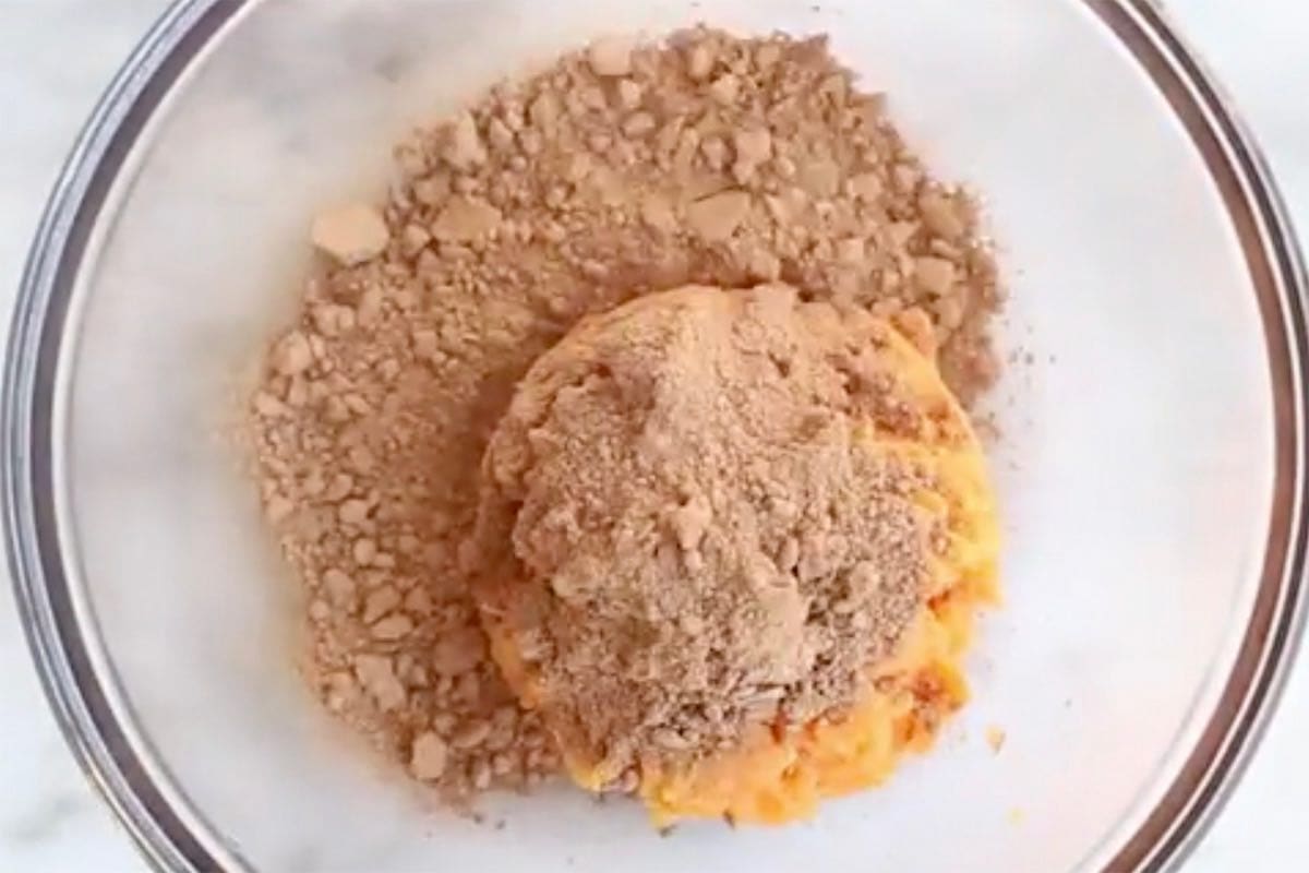 cocoa powder, mashed sweet potato, maple syrup, and almond butter in a bowl.
