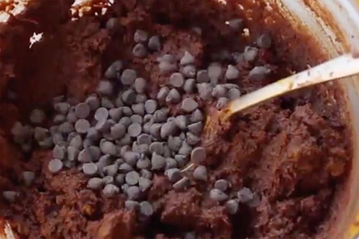 adding chocolate chips to brownie batter.