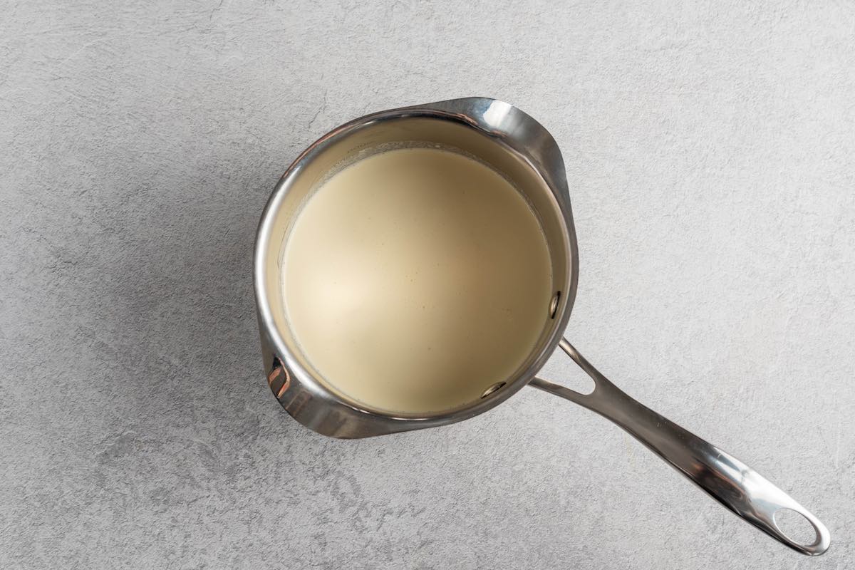 cream heating up in a small saucepan.