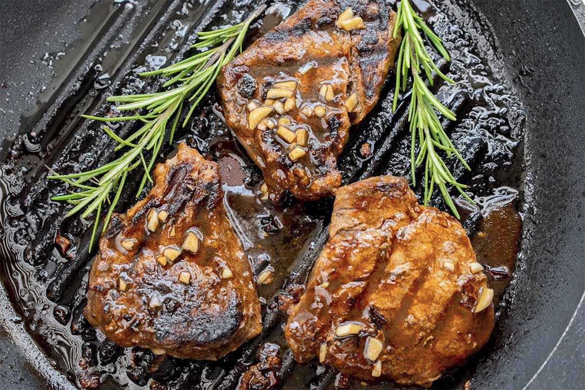 cooking marinated steaks.