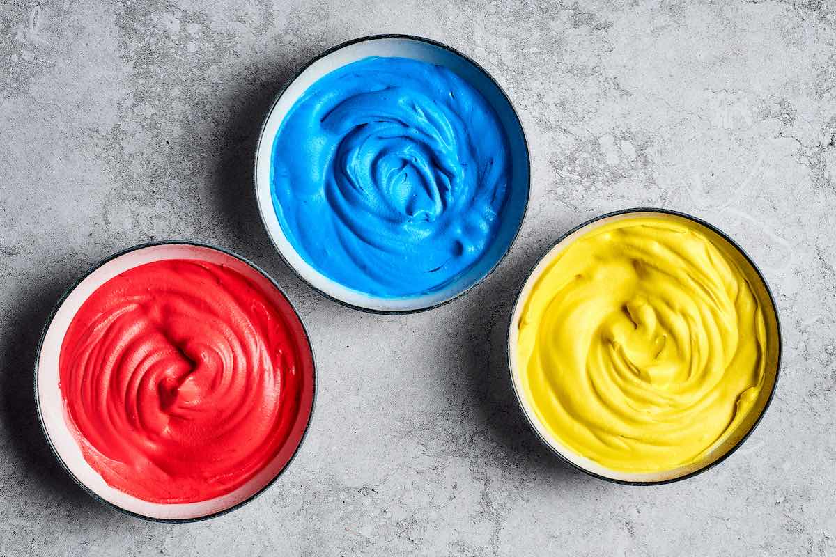 bowls of red, blue, and yellow ice cream.