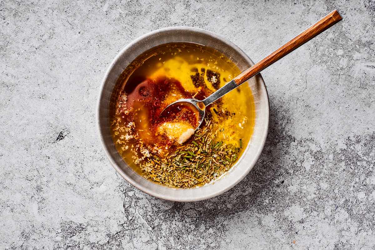 melted butter with herbs in a bowl.
