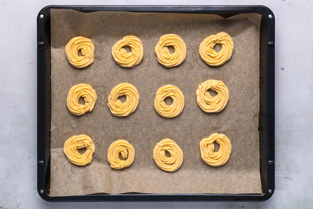 piped butter cookies on baking sheet.