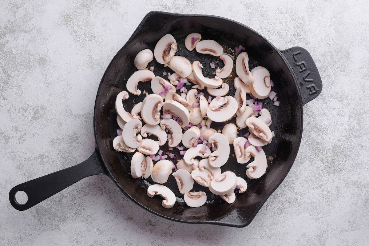 sauteed mushrooms and onions in a skillet.