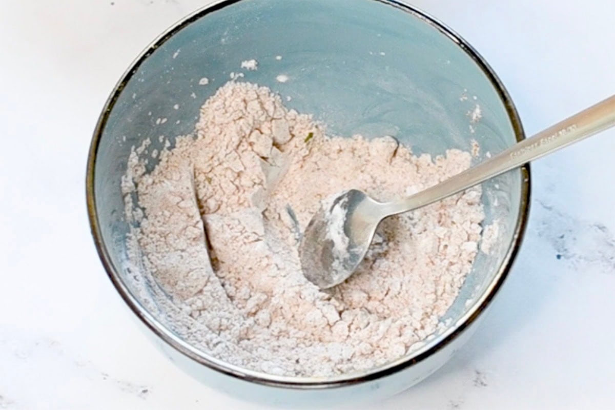 flour, salt, pepper, and Chinese five spice in bowl.